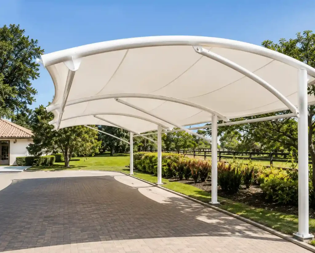 Luxury pyramid parking shade installed in a landscaped outdoor area.