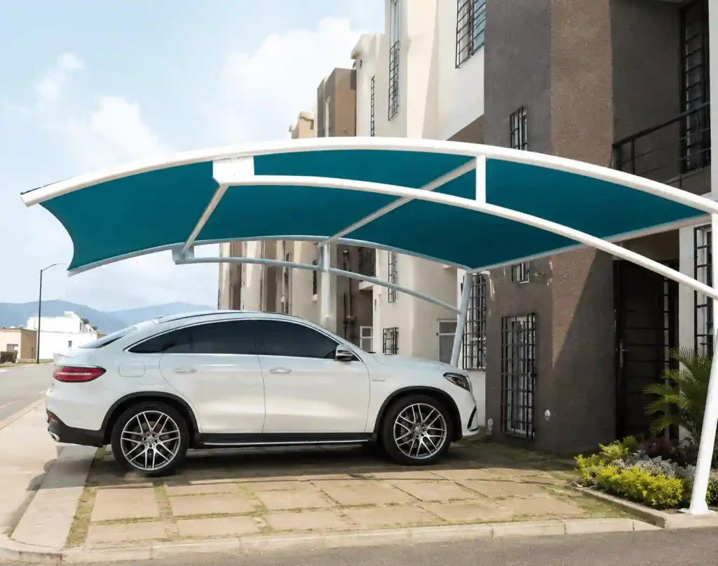 Contemporary blue cantilever parking shade installed outside a residential building.