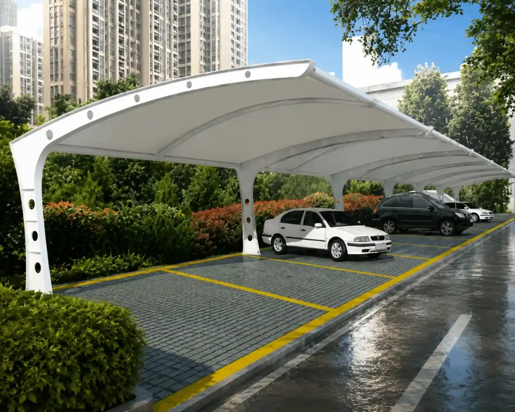 Multi-bay curved parking shade structure installed in a residential parking area protecting multiple vehicles.