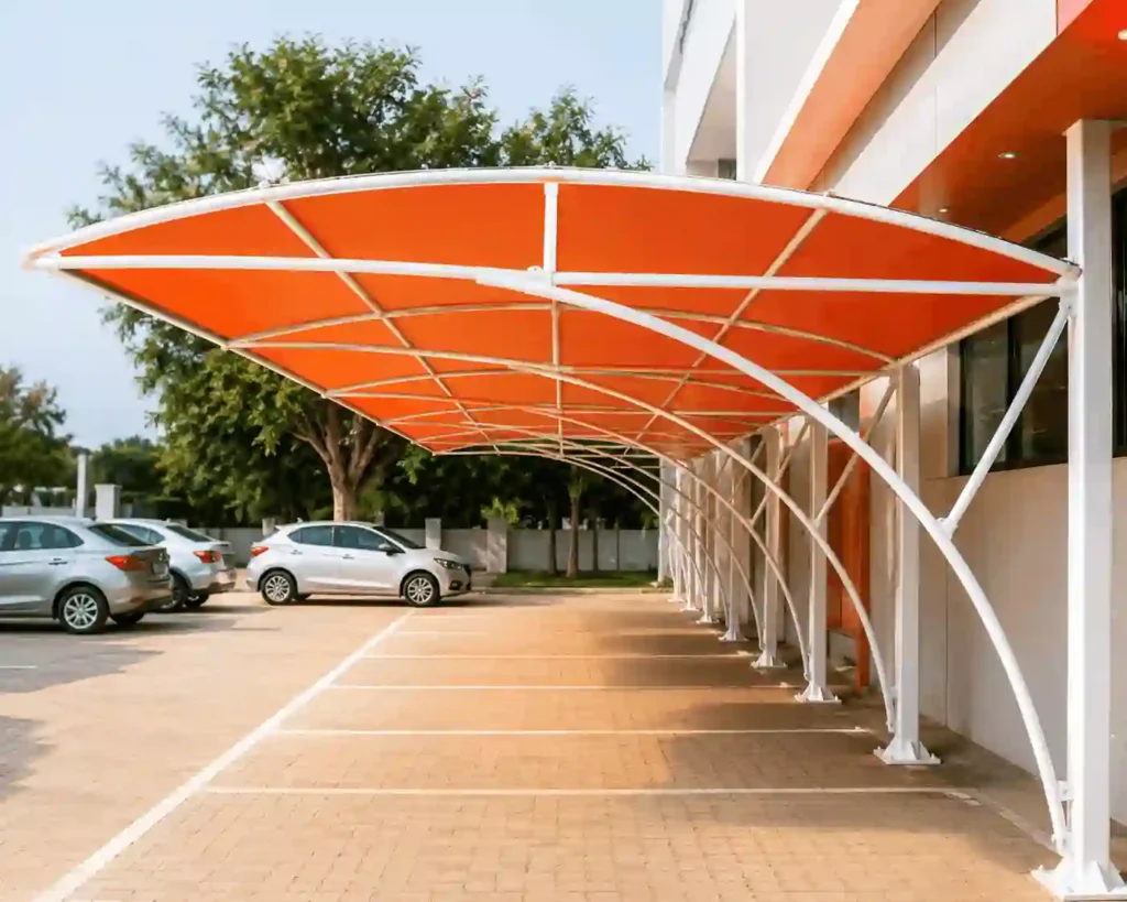 Orange fabric carport shade installed along parking bays.