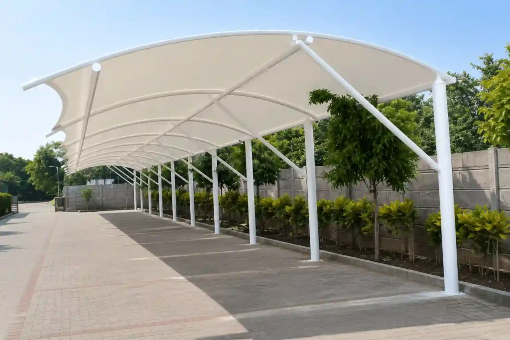 Extended parking shade structure installed beside residential property.