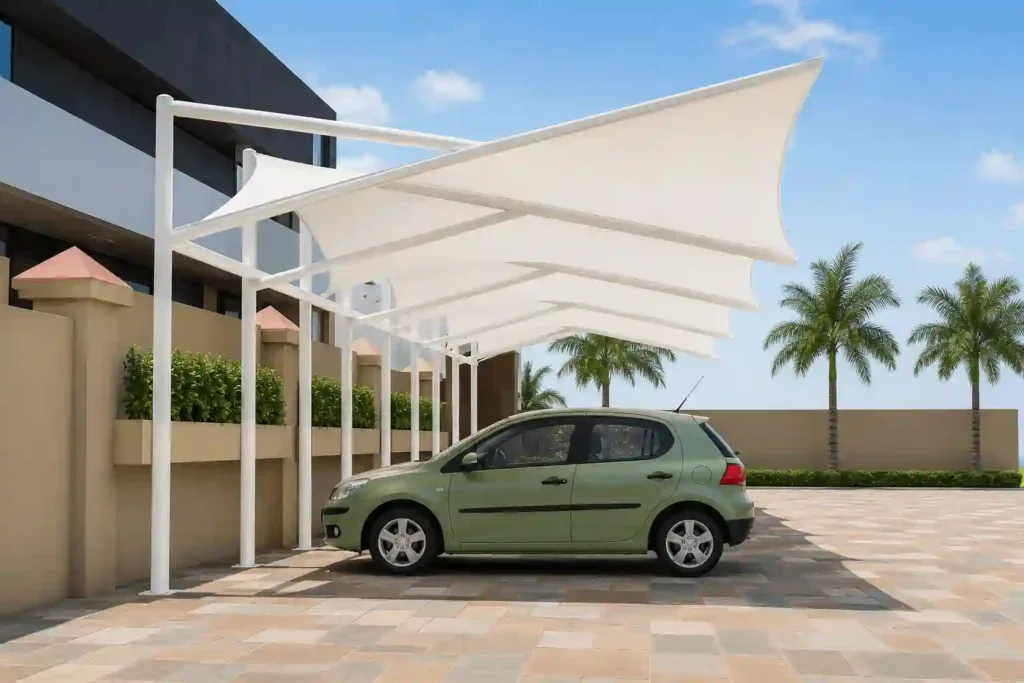 Modern wave fabric canopy shade installed over a residential vehicle parking area.
