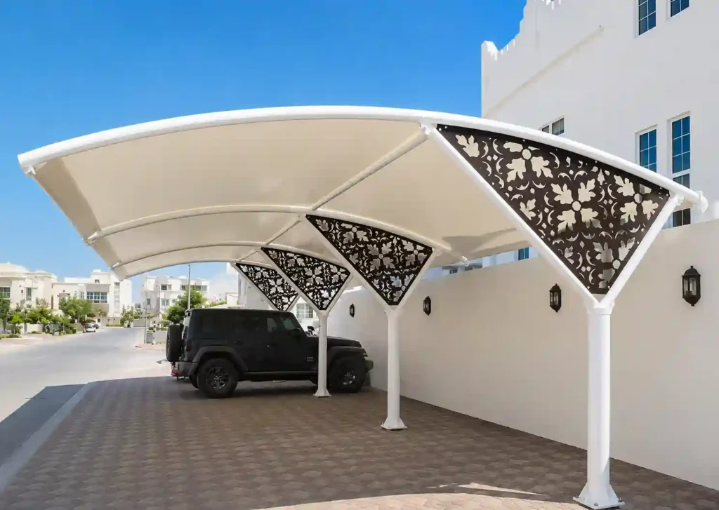 Decorative cantilever parking shade beside residential buildings.