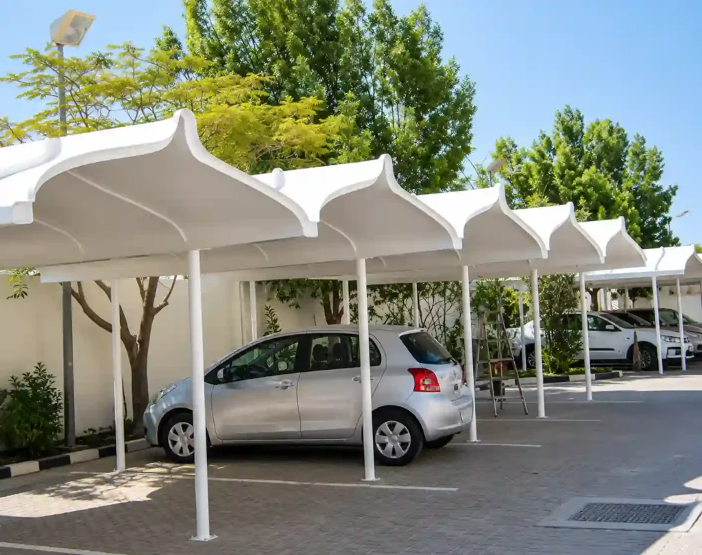 Modern car parking shade structure protecting parked vehicles.