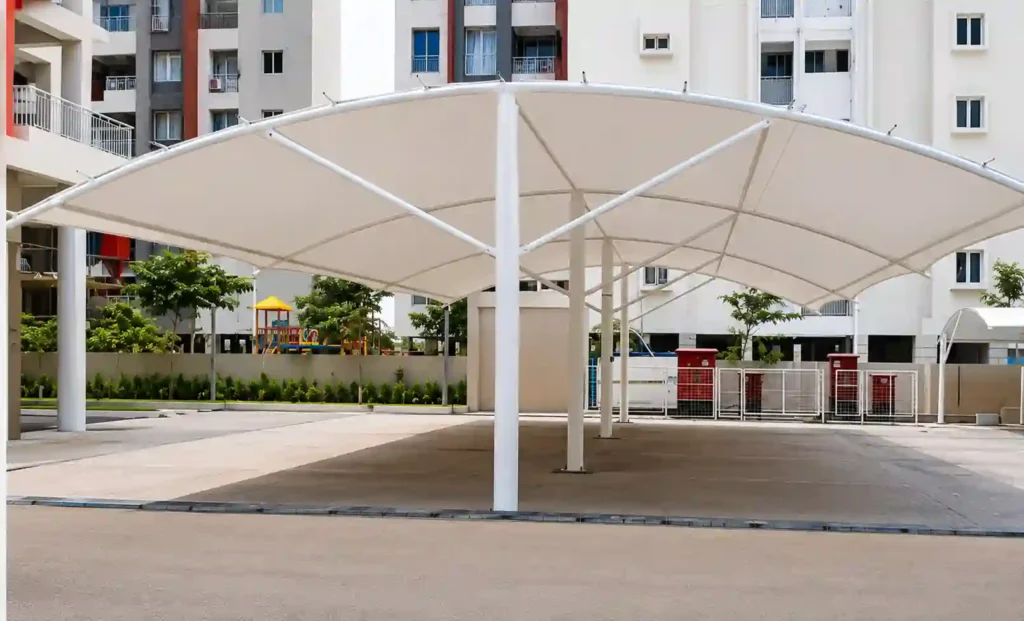 Modern residential car parking shade canopy installed for vehicle protection in a residential complex.