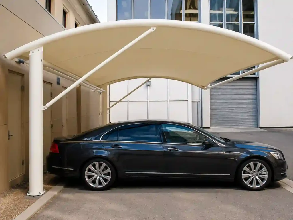 Single car parked under a curved white shade canopy.
