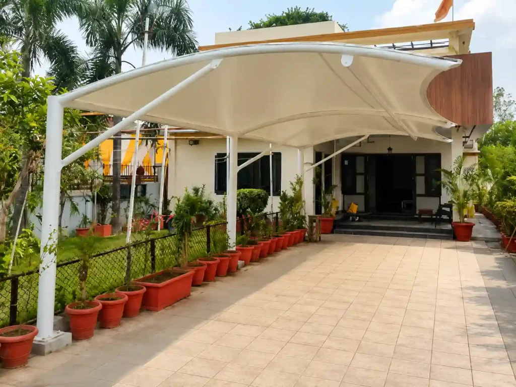 Modern tensile car parking shade canopy installed at a residential property, showcasing professional car parking shade installation in Saudi Arabia.