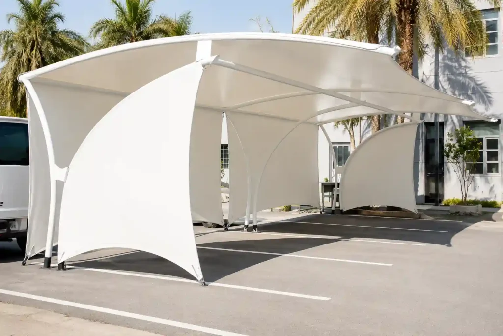 Tensile car parking shade structure with fabric canopy