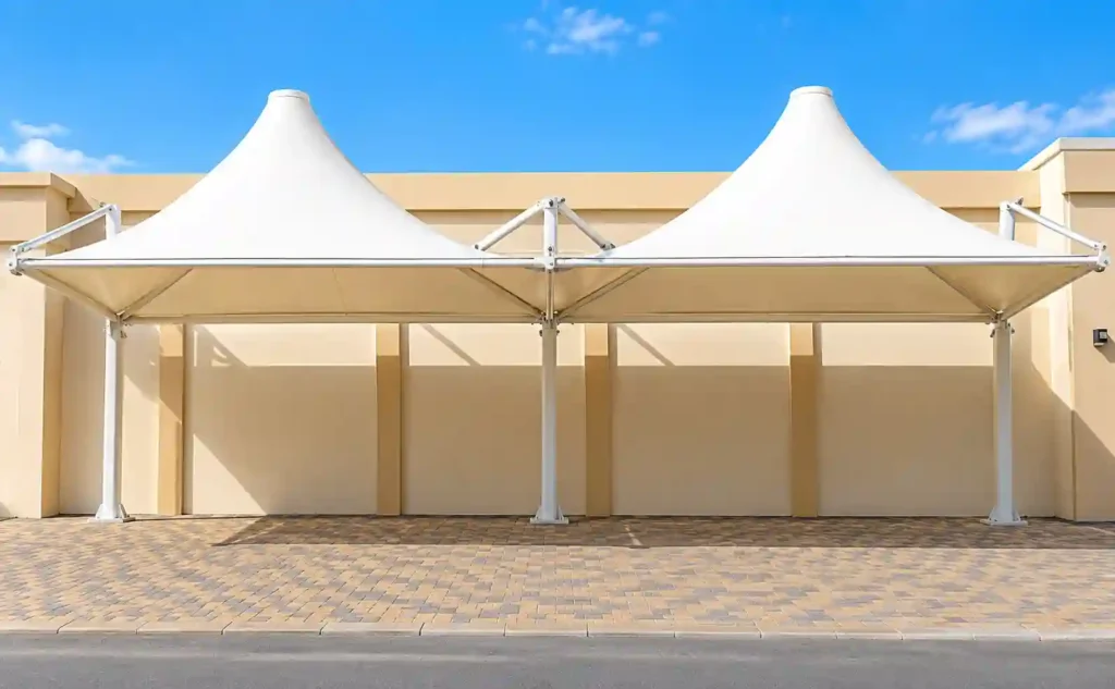 Tensile car parking shade structure for outdoor parking.